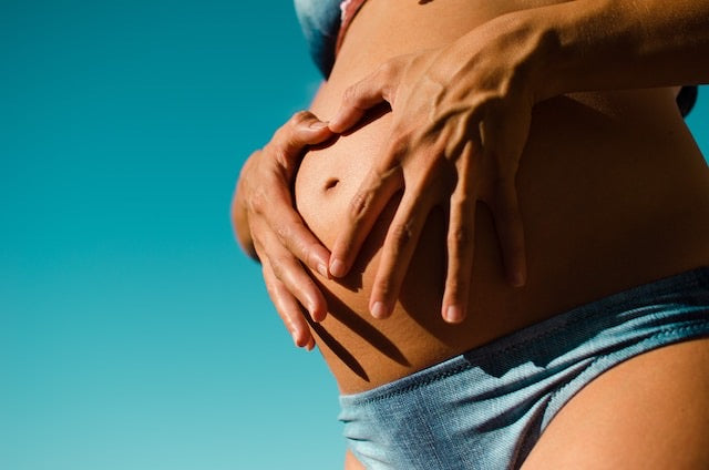 Pregnant woman holding her belly